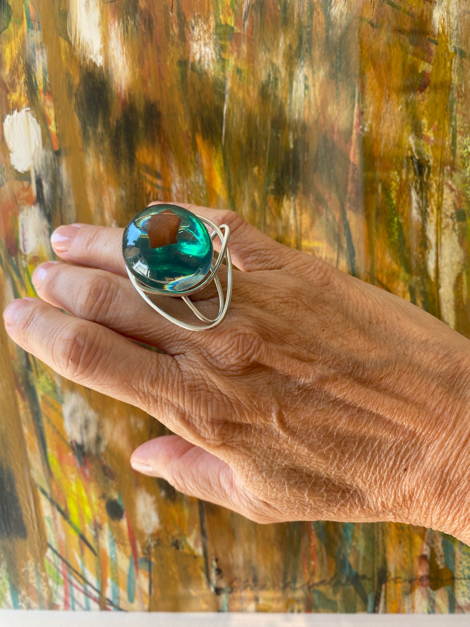 Click here to view The Planets: anel verde com aros by Silvana LaCreta Ravena